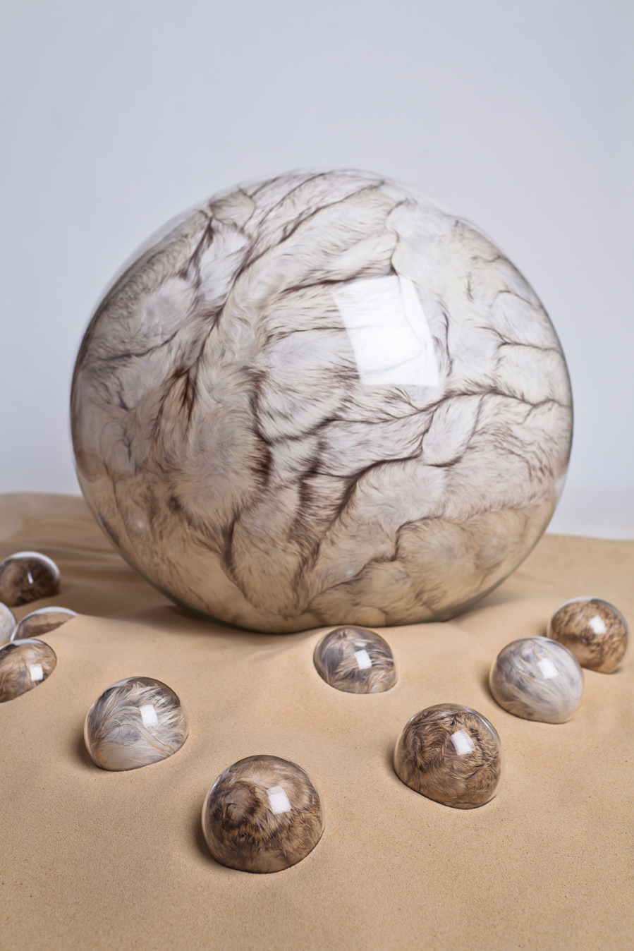 Adeline de Monseignat, Mother HEB:Loleta, 2012, vintage fur, pillow filler, glass, motor, wood on 2 tonnes of sand, main glass sphere 68 cm, ten smaller spheres 10 cm, variable installation